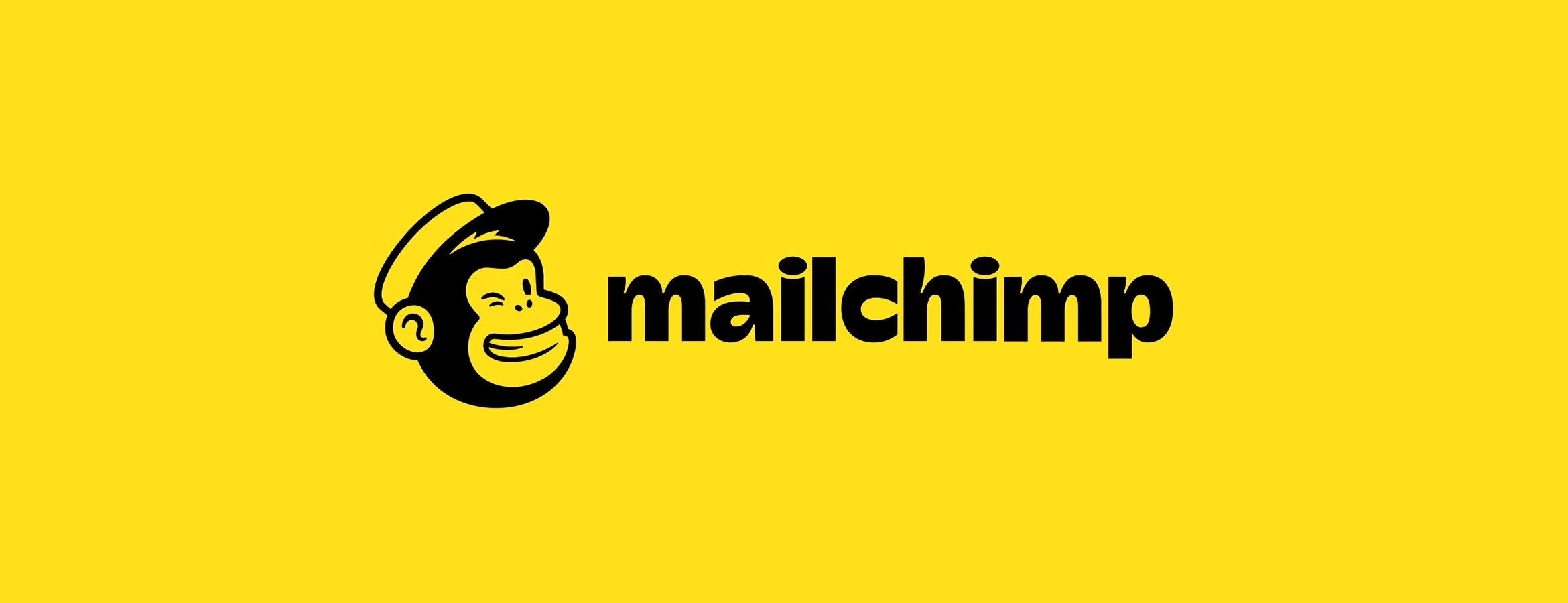 Monkey head and Mailchimp written in black on a yellow background